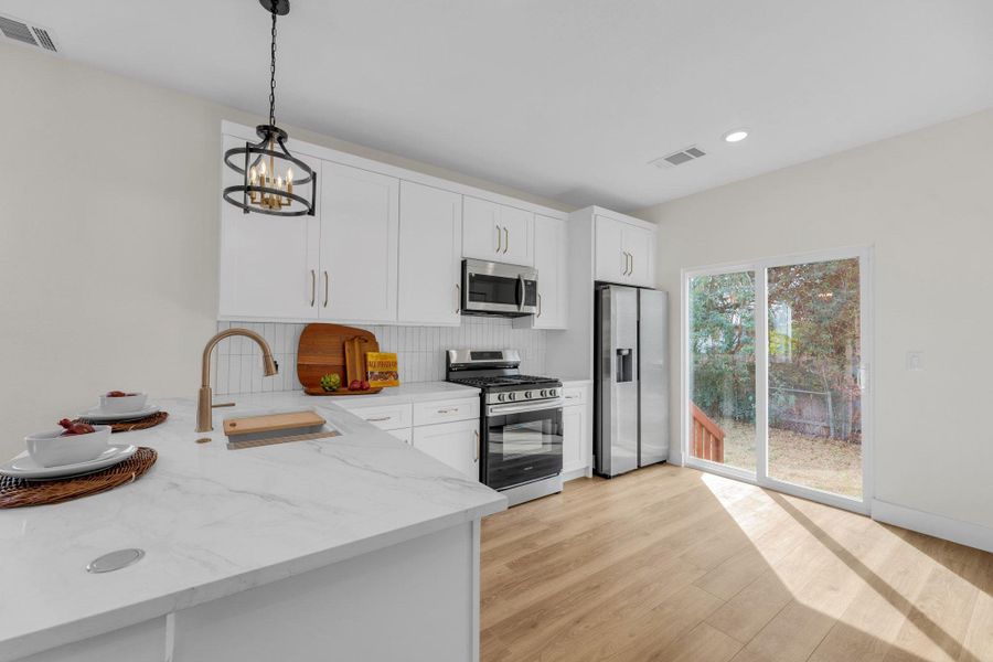Full kitchen in ADU. Sliding glass door to outside fenced in area with gate.