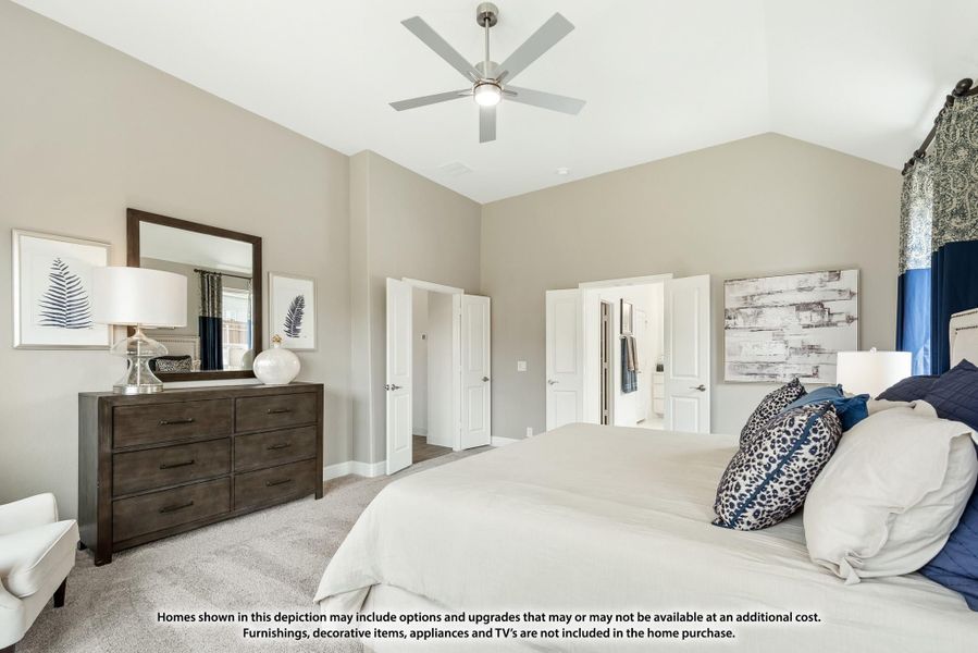 Master bedroom with vaulted ceiling, ceiling fan, carpet floors, and ensuite bathroom access Master bedroom with vaulted ceiling, ceiling fan, carpet floors, and ensuite bathroom access