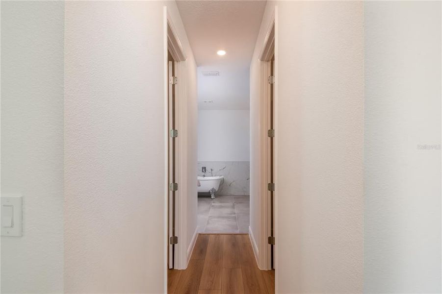 hallway in primary room his/ hers closet hallway in primary room his/ hers closet