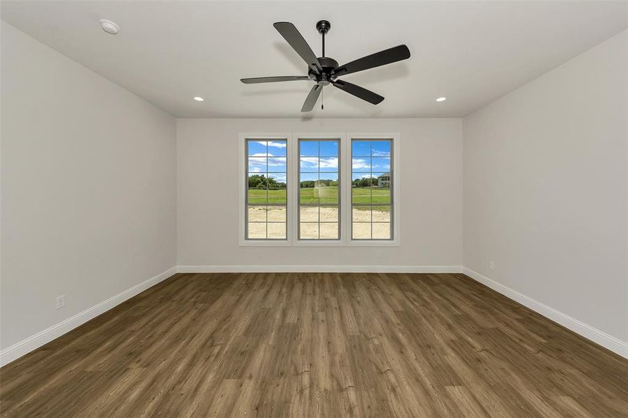 Unfurnished room featuring wood finished floors, ceiling fan, and recessed lighting