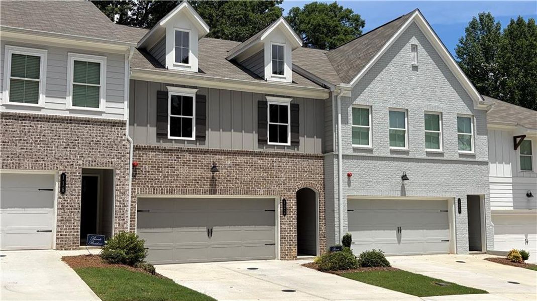 Front exterior of a new home in Bluffs at Bells Ferry, Marietta, GA, highlighting curb appeal (Image 1). Front exterior of a new home in Bluffs at Bells Ferry, Marietta, GA, highlighting curb appeal (Image 1).