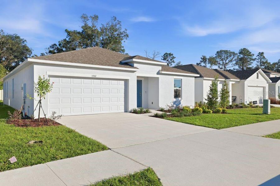 Front exterior of a new home in Palm Wind, Hudson, FL, highlighting curb appeal (Image 17).