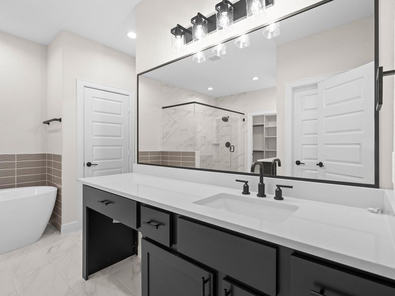 The thoughtfully designed primary bathroom in the ROCcreek offers a refined escape featuring sophisticated details, generous space, and a seamless blend of comfort and functionality for elevated daily living. Image depicts home as-is.