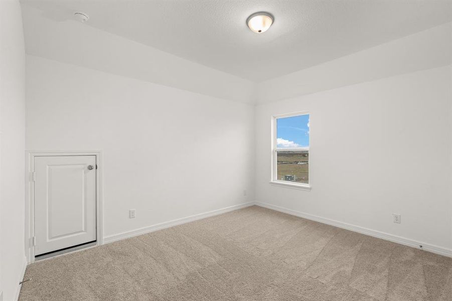 Your secondary bedroom features plush carpet, fresh paint, closet, and a large window that lets in plenty of natural lighting.