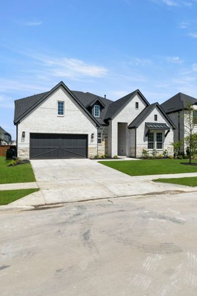 Front exterior of a new home in Cambridge Crossing, Celina, TX, highlighting curb appeal (Image 25). Front exterior of a new home in Cambridge Crossing, Celina, TX, highlighting curb appeal (Image 25).