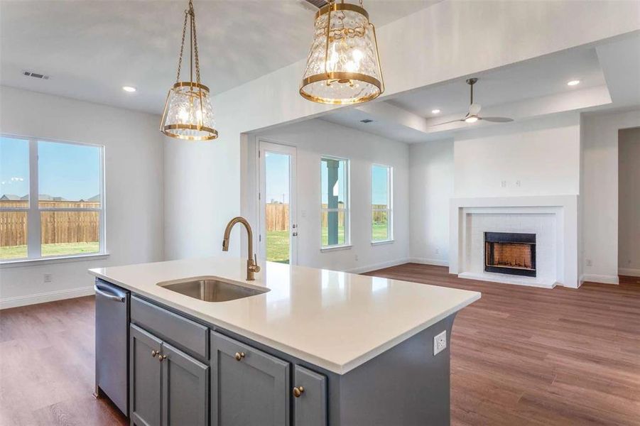 Kitchen with gray cabinetry, open floor plan, dark wood finished floors, pendant lighting, and recessed lighting Kitchen with gray cabinetry, open floor plan, dark wood finished floors, pendant lighting, and recessed lighting