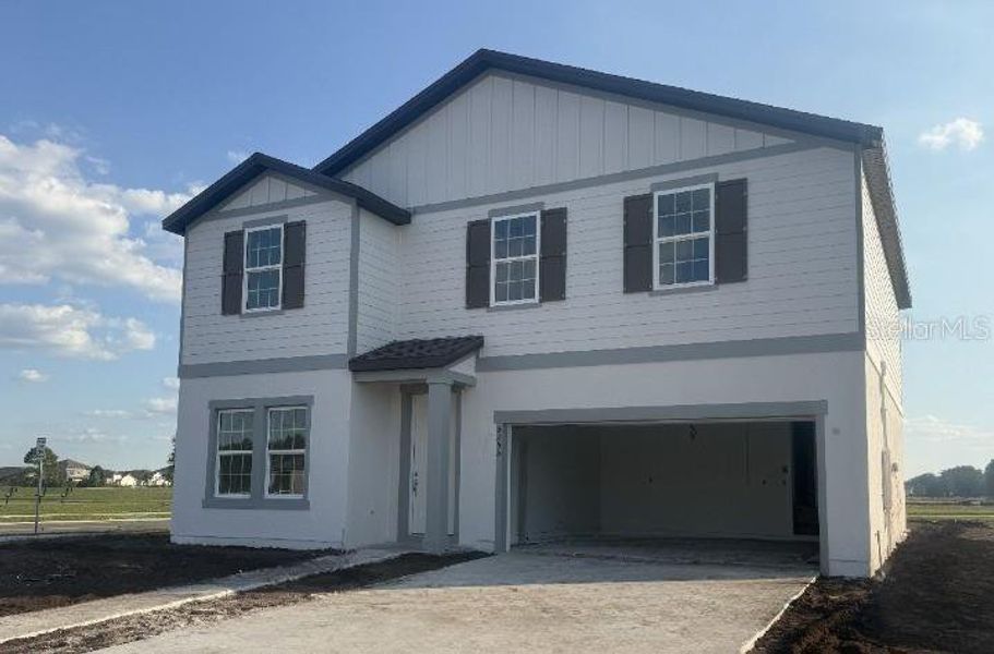 Front exterior of a new home in Tyson Reserve, St. Cloud, FL, highlighting curb appeal (Image 5). Front exterior of a new home in Tyson Reserve, St. Cloud, FL, highlighting curb appeal (Image 5).