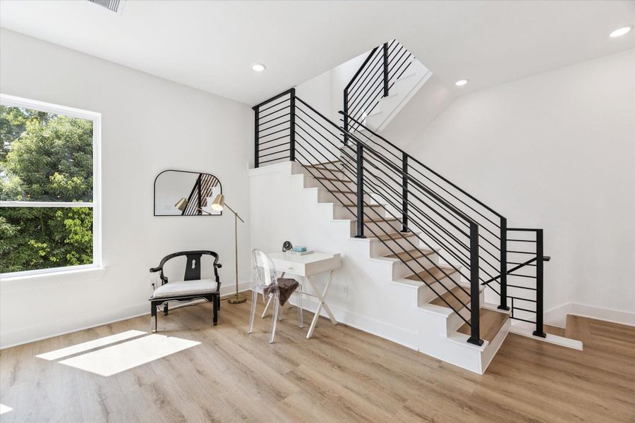 Adjacent to the living level open staircase is more square footage, an ideal spot for a smaller sitting area or at home work nook. Adjacent to the living level open staircase is more square footage, an ideal spot for a smaller sitting area or at home work nook.