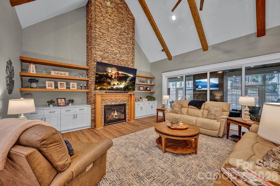 Anchoring the main level, the 2-story, cathedral ceiling Great Room offers a floor-to-ceiling stone fireplace and access to the All Seasons Room.