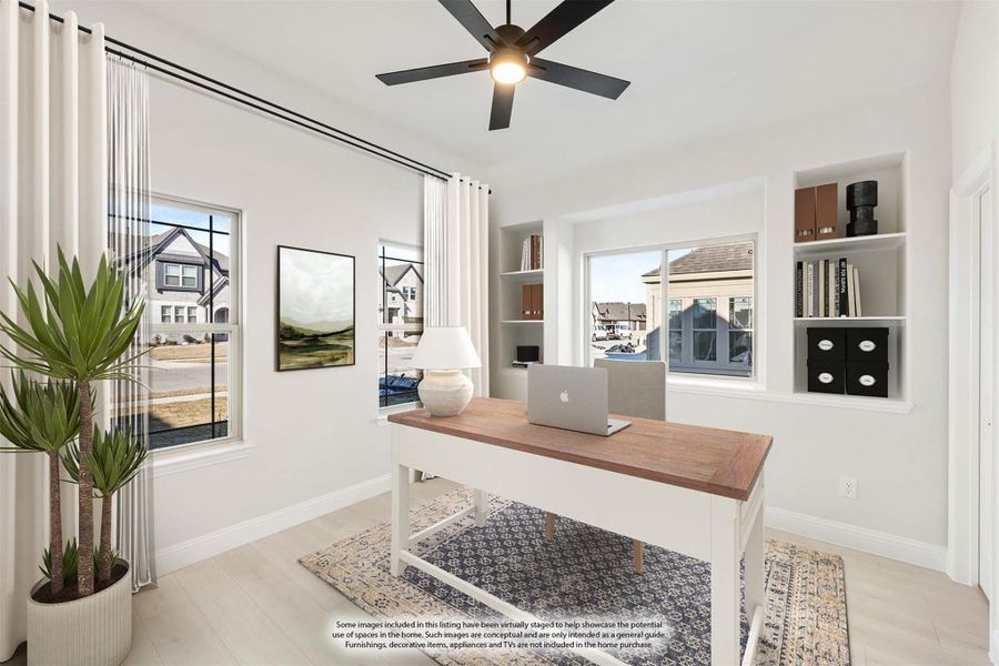 Home office with wood desk, built-in shelves, ceiling fan, and large windows with neighborhood views