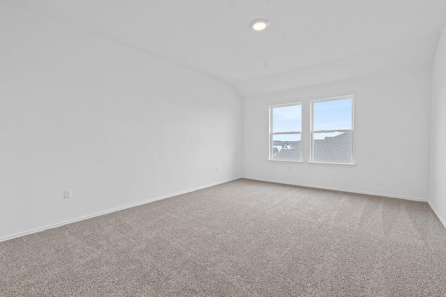 Empty room featuring lofted ceiling, carpet, and recessed lighting Empty room featuring lofted ceiling, carpet, and recessed lighting