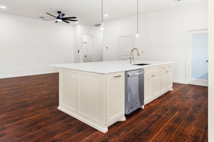 Kitchen with sink, stainless steel dishwasher, ceiling fan, and dark hardwood / wood-style floors