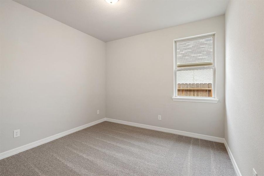 Your secondary bedroom features plush carpet, fresh paint, closet, and a large window that lets in plenty of natural lighting.