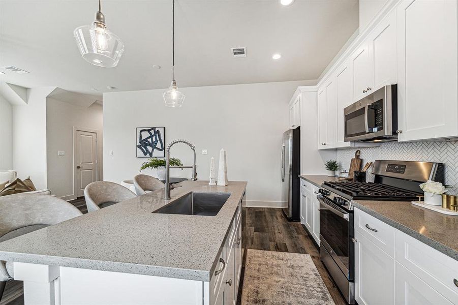 Two stylish light pendants hang over the kitchen island.