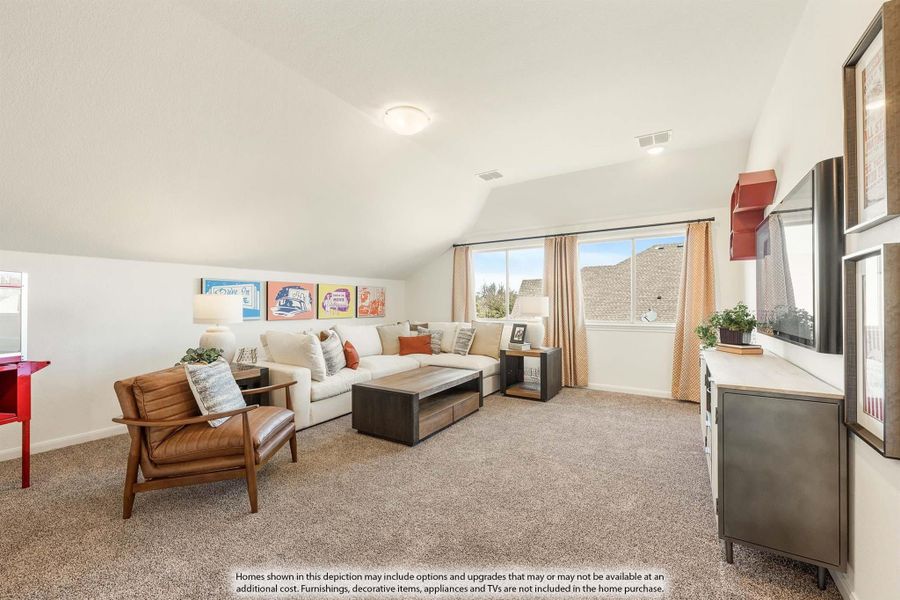 Upstairs bonus room with vaulted ceiling, carpet flooring, sectional sofa, and wall-mounted TV Upstairs bonus room with vaulted ceiling, carpet flooring, sectional sofa, and wall-mounted TV