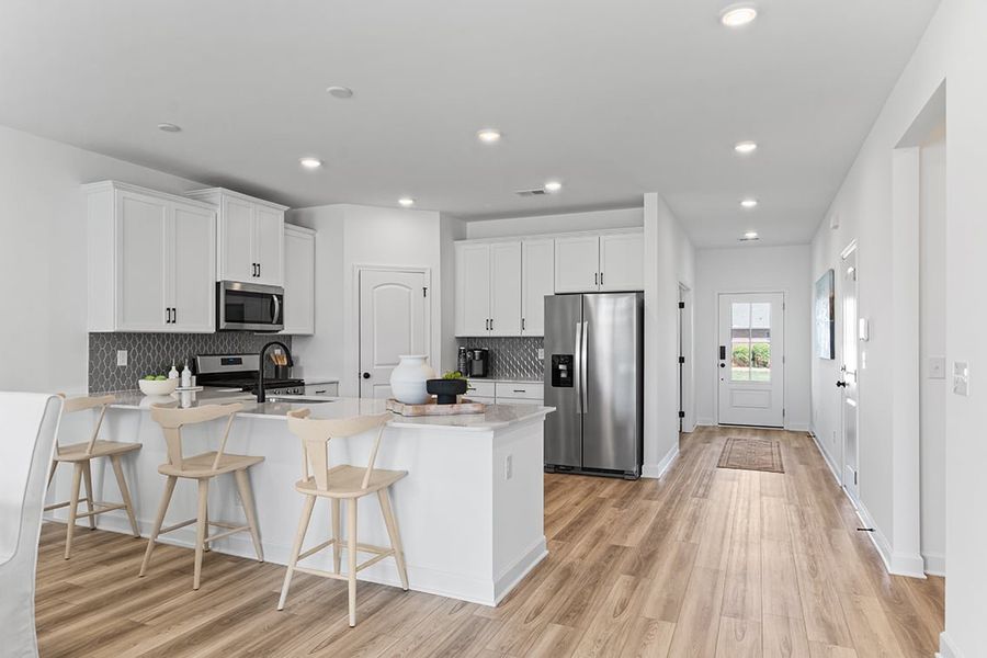 A kitchen with white cabinets.