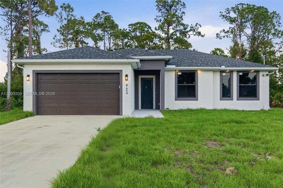 Front exterior of a new home in , Lehigh Acres, FL, highlighting curb appeal (Image 26).