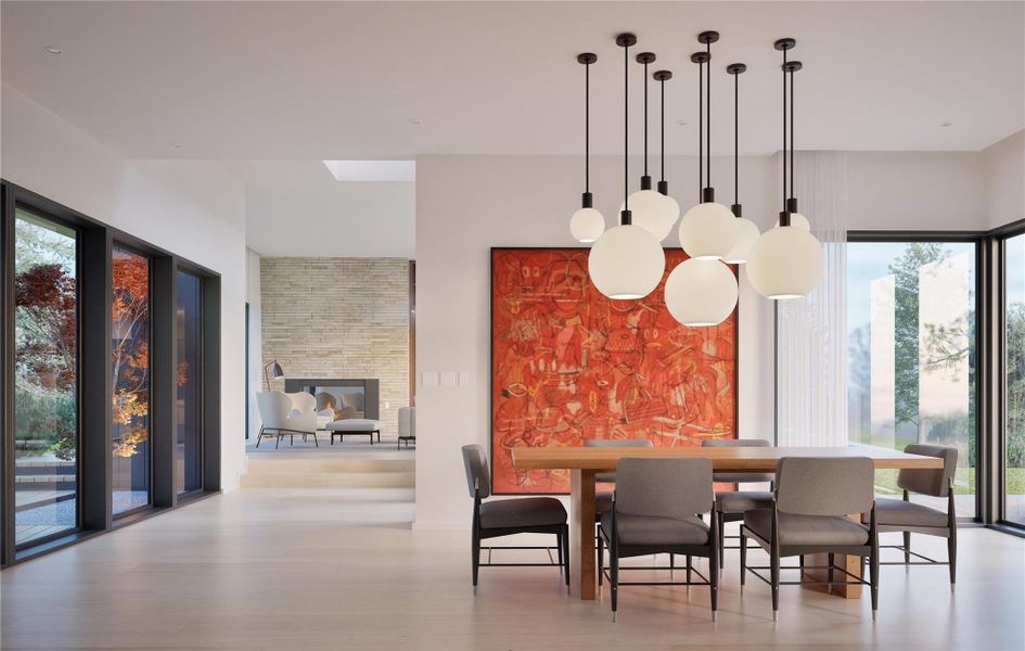Dining space with wood finished floors, a stone fireplace, and a skylight