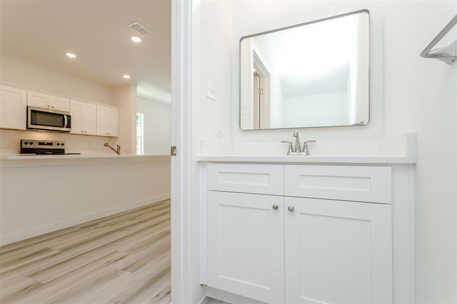 Bathroom with hardwood / wood-style flooring and oversized vanity