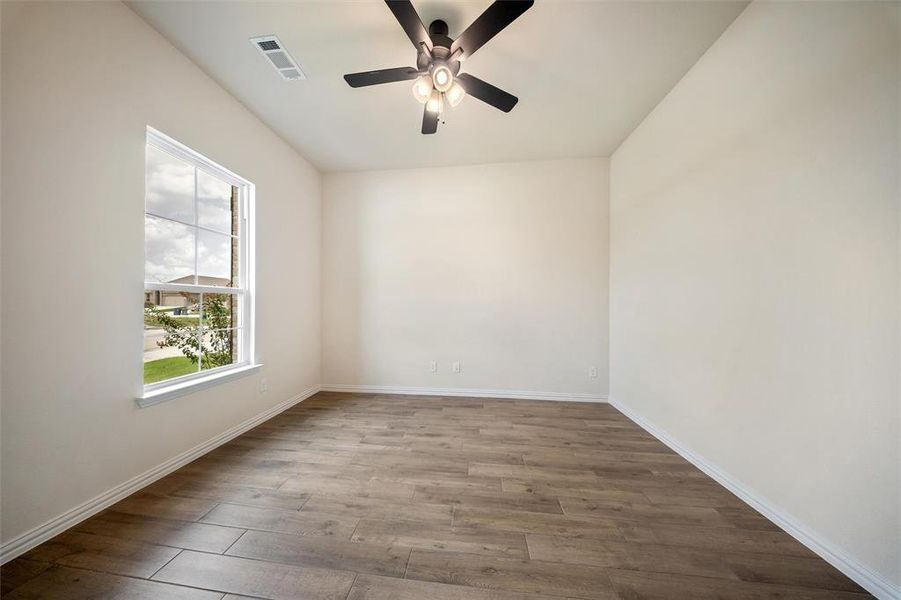 Unfurnished room with wood finished floors and ceiling fan