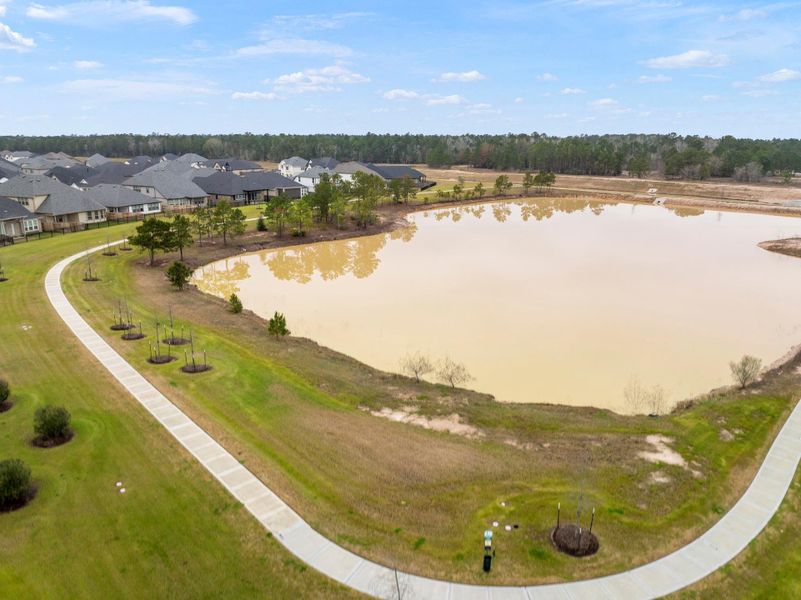The pond with walking trails behind the property. Fountains are being installed. The pond with walking trails behind the property. Fountains are being installed.