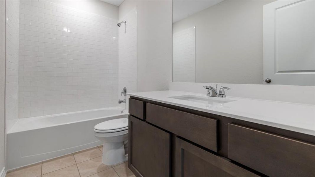 Full bathroom with vanity, tub / shower combination, and light tile patterned floors
