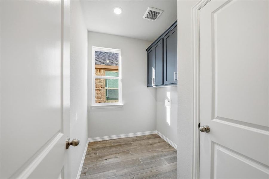 Laundry room with wood tiled floors, recessed lighting, cabinet space, and washer hookup Laundry room with wood tiled floors, recessed lighting, cabinet space, and washer hookup