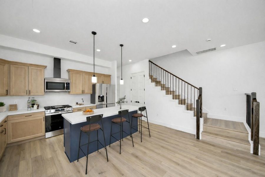 Bright, open-concept layout with a spacious island, modern finishes, and great natural light—perfect for everyday living and entertaining.