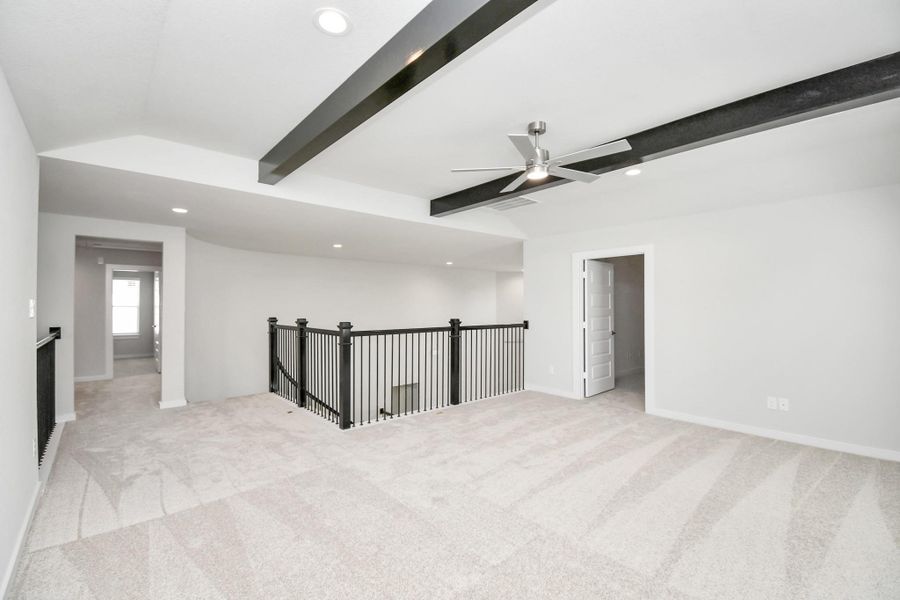 Ascend to relaxation in this fantastic game room! Ideal for both casual gatherings and adult gaming, it boasts plush carpet, lofty ceilings, custom paint, and ample windows for abundant natural light. Sample photo of completed home with similar floor plan. Actual colors and selections may vary.