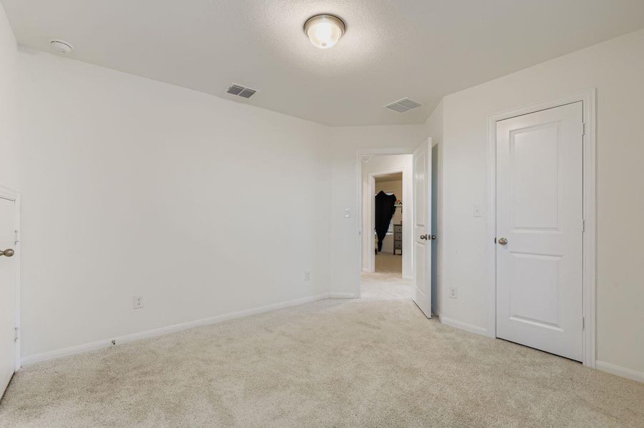 Unfurnished bedroom with carpet flooring and baseboards