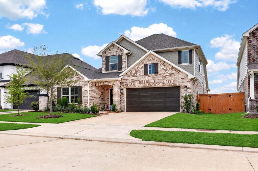 Front exterior of a new home in Marvida, Cypress, TX, highlighting curb appeal (Image 2). Front exterior of a new home in Marvida, Cypress, TX, highlighting curb appeal (Image 2).