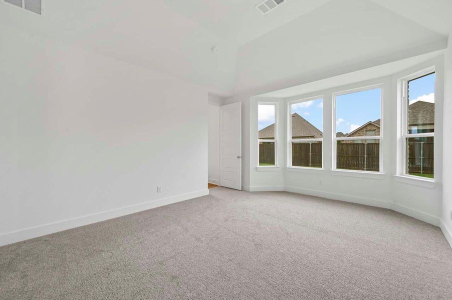Spare room with baseboards, light carpet, and visible vents