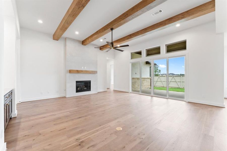 Family Room with Sliding Glass Doors, Gas-log Fireplace, and Floor Outlet.