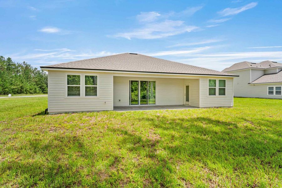 Dogwood Plan Lot 581 Rear Exterior with Covered Patio at NorthShore in Kingsland