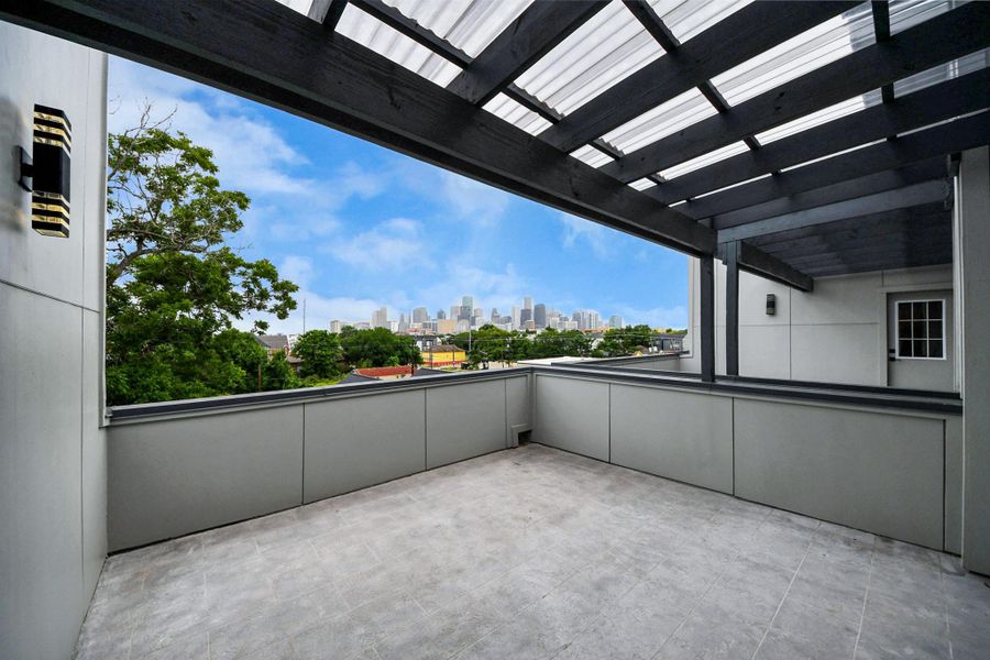 Spacious rooftop terrace with modern railing, partial pergola for shade, and stunning city skyline views. Perfect for entertaining or relaxing outdoors. Spacious rooftop terrace with modern railing, partial pergola for shade, and stunning city skyline views. Perfect for entertaining or relaxing outdoors.