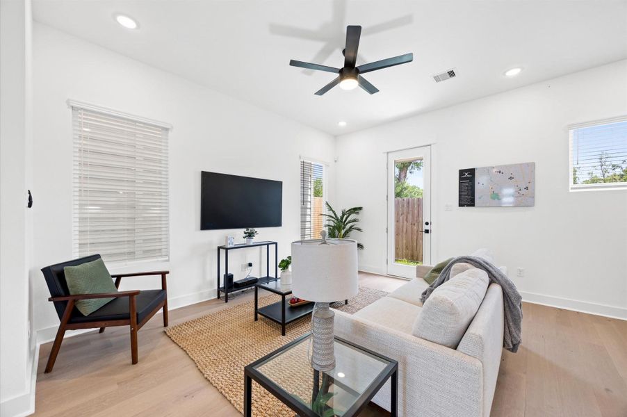 An open-concept living room seamlessly blends with adjacent spaces, creating a spacious and inviting atmosphere. Large windows allow natural light to flood in. An open-concept living room seamlessly blends with adjacent spaces, creating a spacious and inviting atmosphere. Large windows allow natural light to flood in.