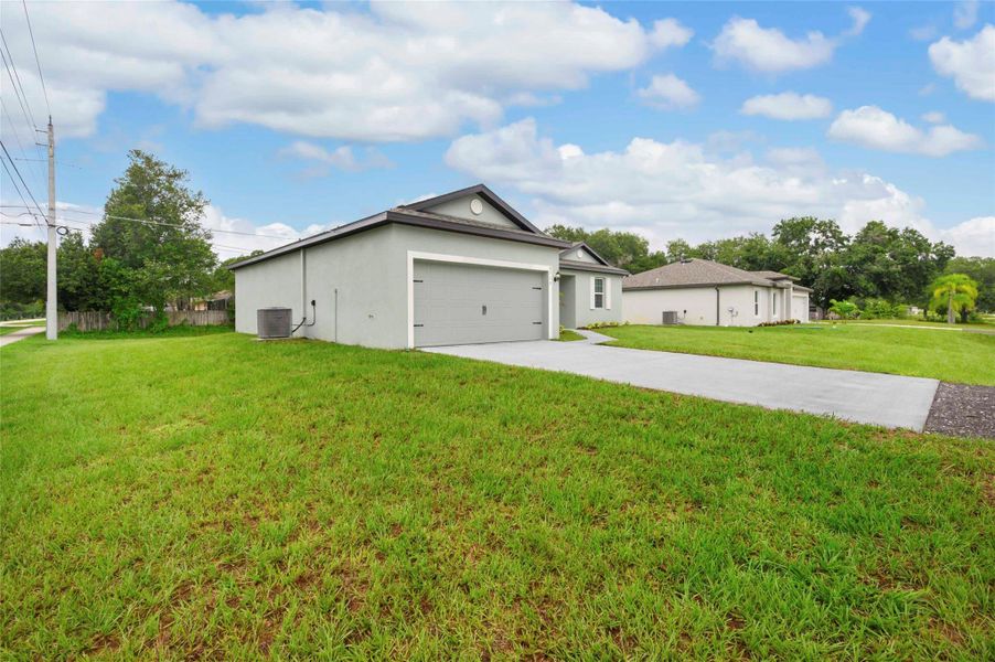 Front exterior of a new home in Vero Lake Estates, Vero Beach, FL, highlighting curb appeal (Image 1). Front exterior of a new home in Vero Lake Estates, Vero Beach, FL, highlighting curb appeal (Image 1).