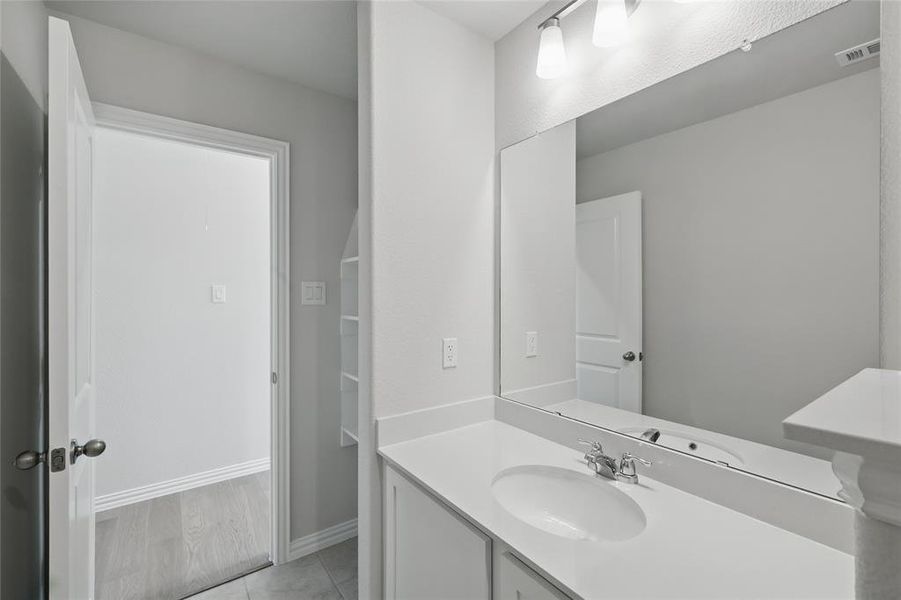 Bathroom featuring vanity and tile patterned flooring Bathroom featuring vanity and tile patterned flooring