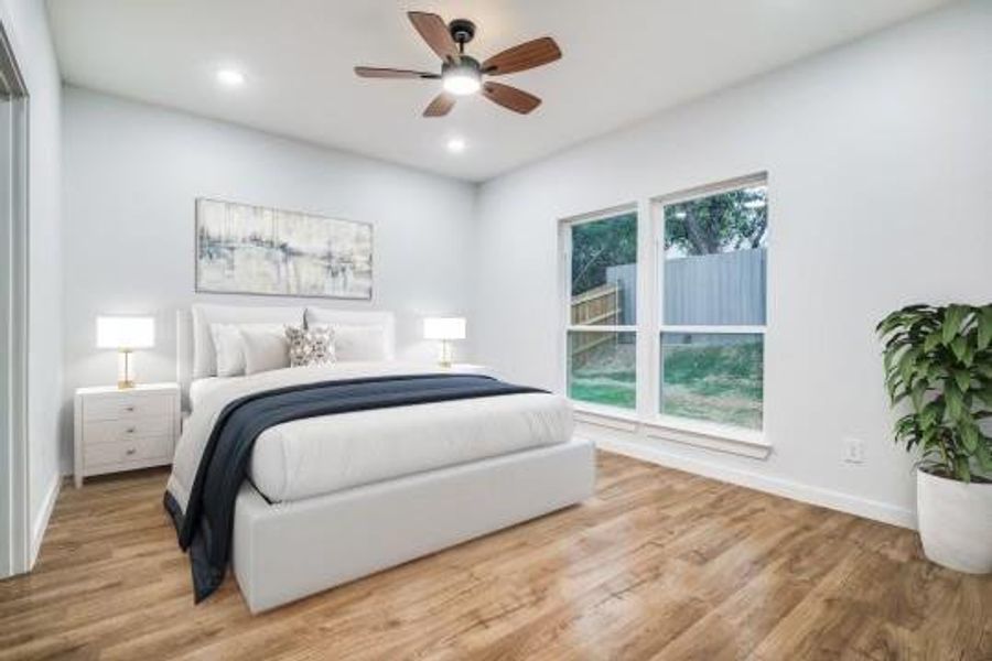 Bedroom featuring ceiling fan and light hardwood / wood-style flooring