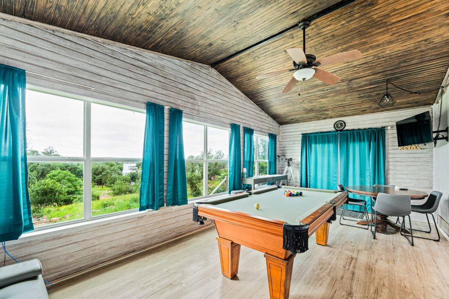 Vaulted wood-paneled ceiling with an integrated ceiling fan