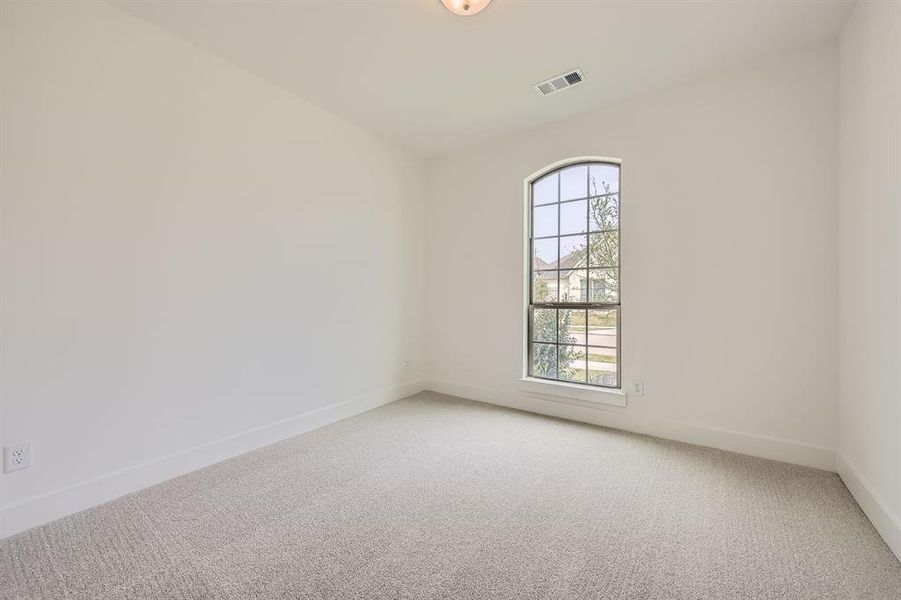 Empty room with light carpet and baseboards
