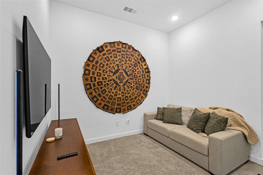 Carpeted living area with baseboards