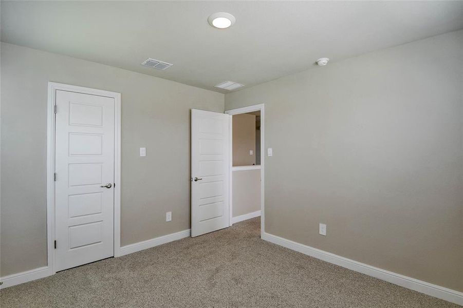 Unfurnished bedroom featuring carpet floors and baseboards Unfurnished bedroom featuring carpet floors and baseboards
