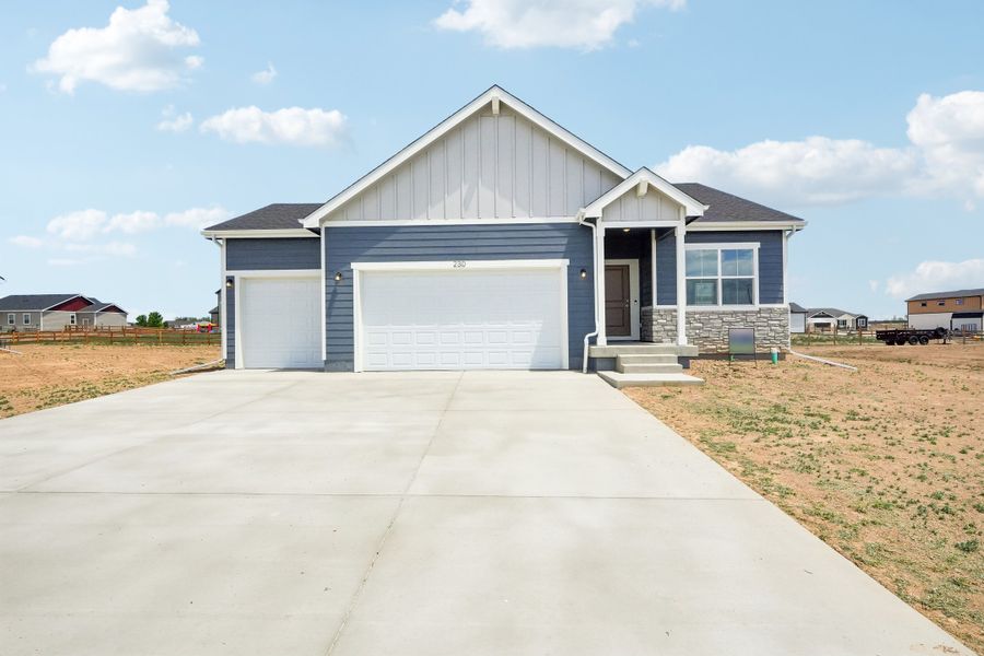 Front exterior of a new home in Hudson Hills, Hudson, CO, highlighting curb appeal (Image 23). Front exterior of a new home in Hudson Hills, Hudson, CO, highlighting curb appeal (Image 23).