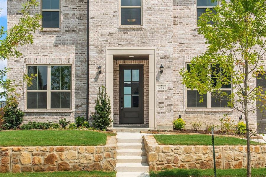 View of exterior entry with a yard