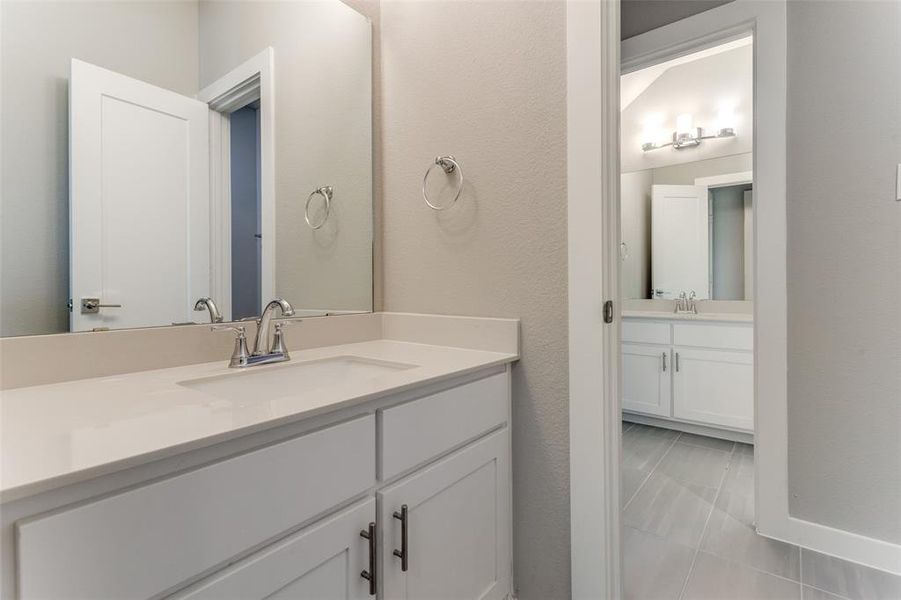 Bathroom featuring tile patterned floors and vanity