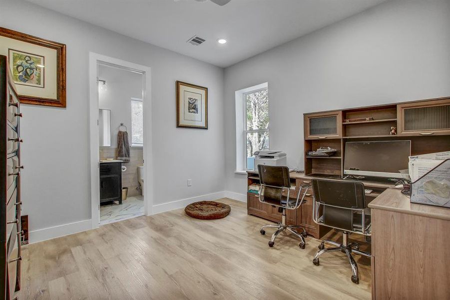Home office featuring light wood finished floors and recessed lighting