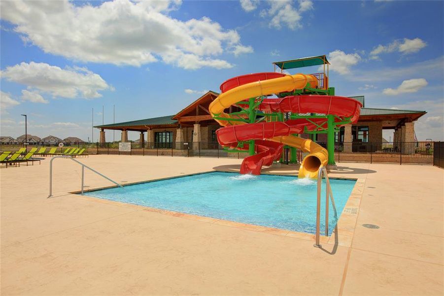 View of swimming pool with a water slide and a patio area