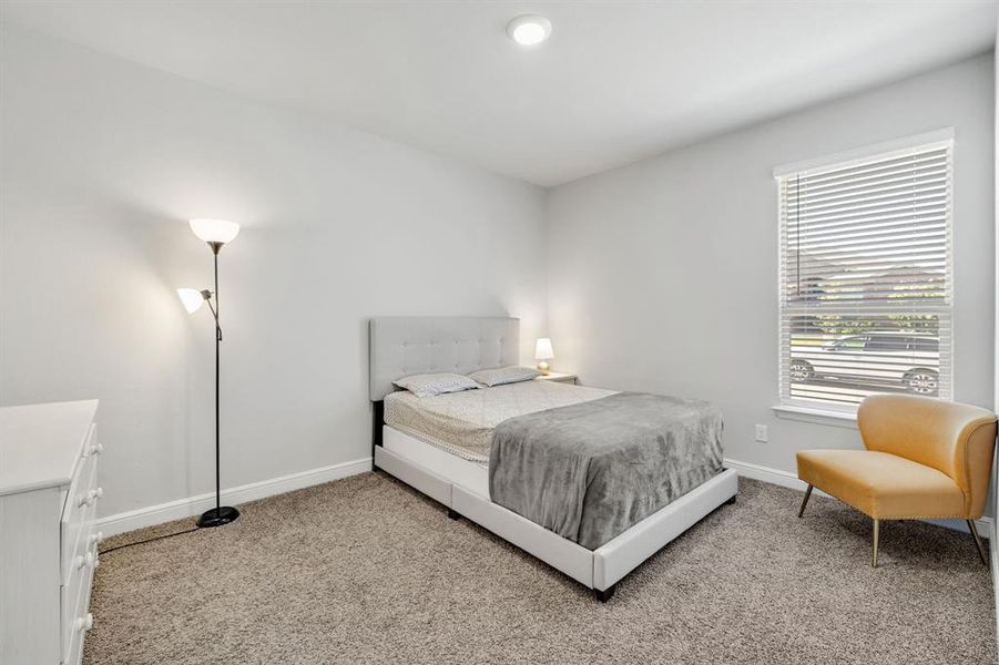 Carpeted bedroom with baseboards