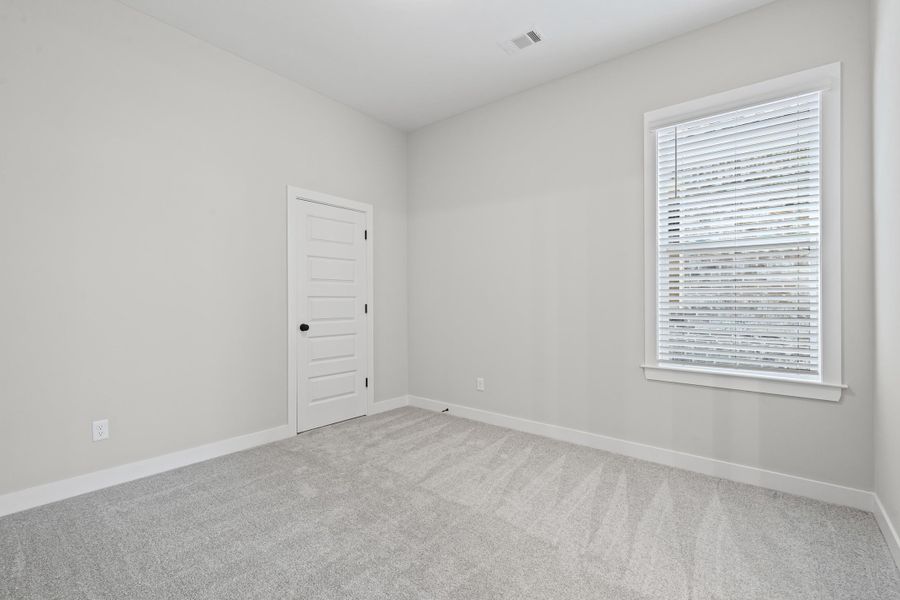 Unfurnished room with light carpet and baseboards